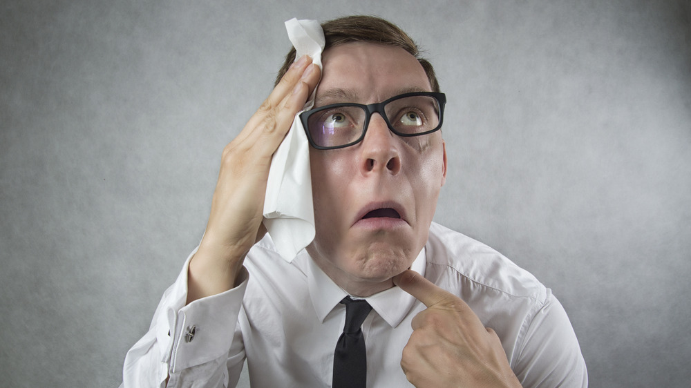 An image of a man wiping off sweat