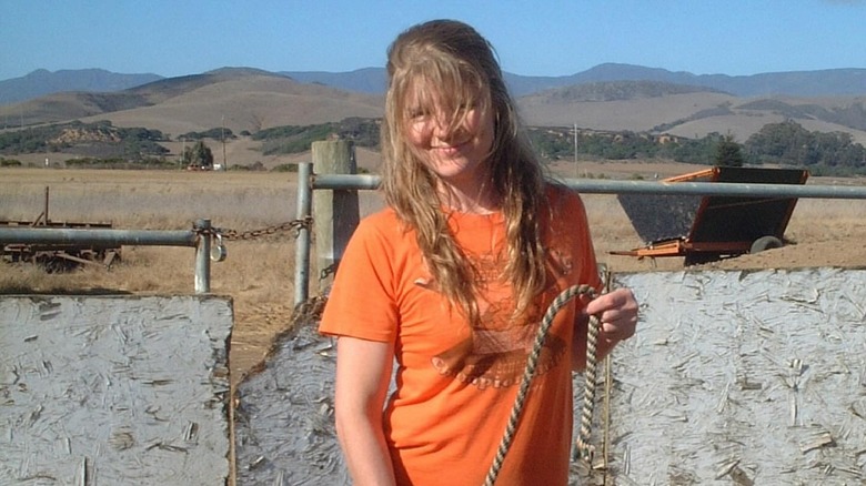 Sarah Becker smiling orange shirt outdoors farm