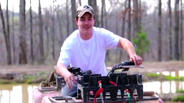 Shain Gandee smiling on ATV in woods