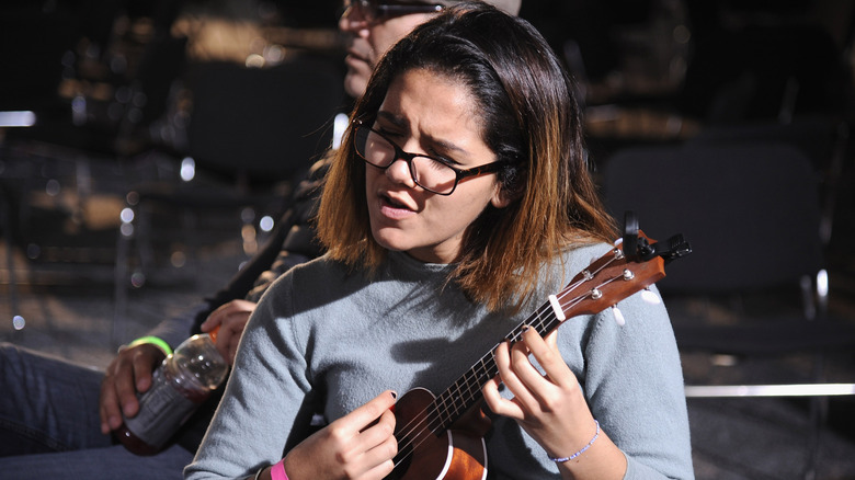 An America's Got Talent contestant playing a ukelele before an audition