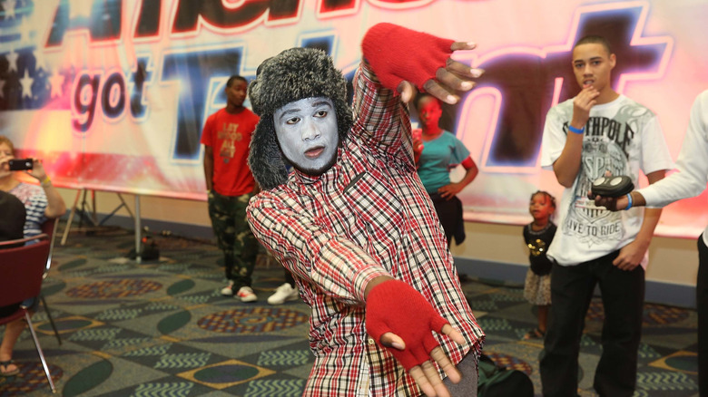 An America's Got Talent contestant making gestures at the audition