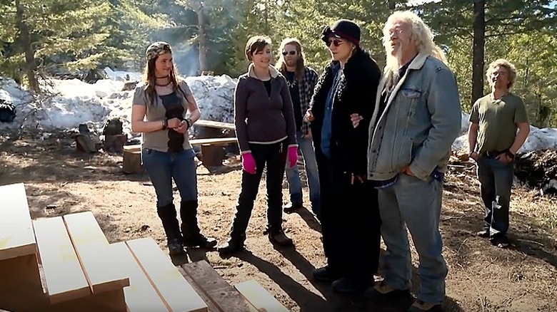 Members of the Brown family stand near wooden stairs