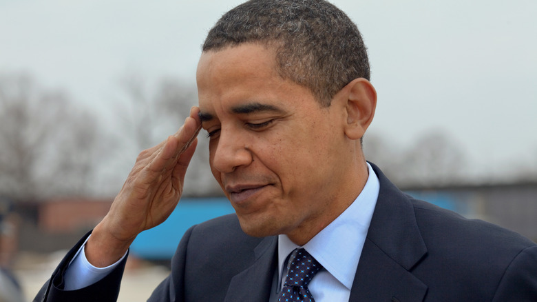 Barack Obama blue suit outside saluting