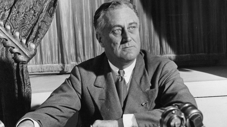 Franklin Roosevelt seated at desk