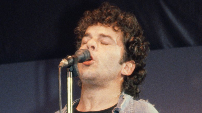 Ian Dury eyes closed singing into mic