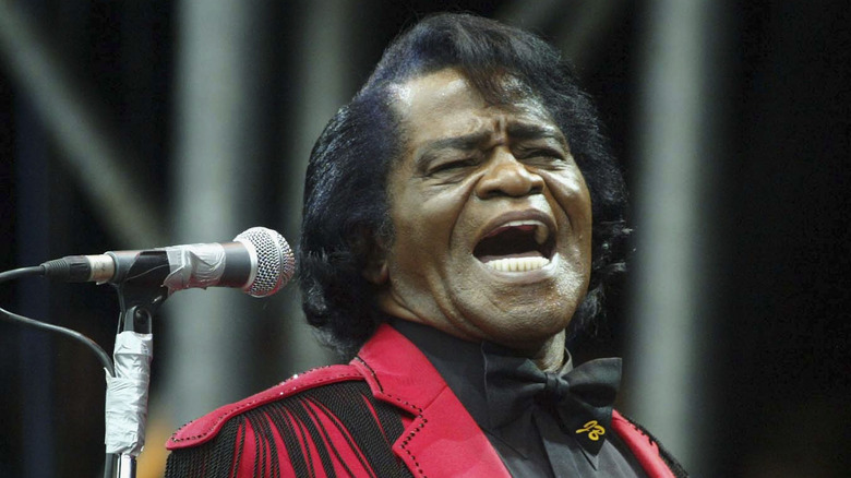 James Brown in stage in maroon suit