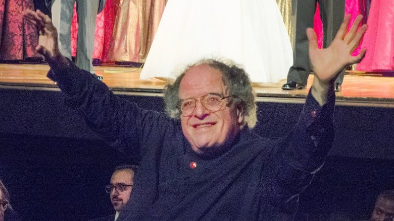 James Levine arms raised blue shirt smiling