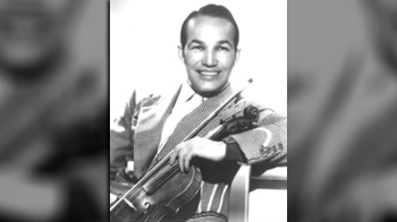 Spade Cooley smiling holding violin