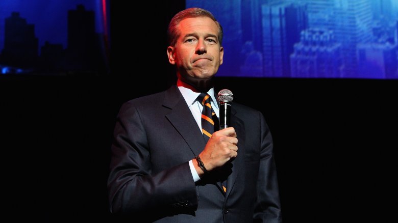brian williams holding microphone on stage