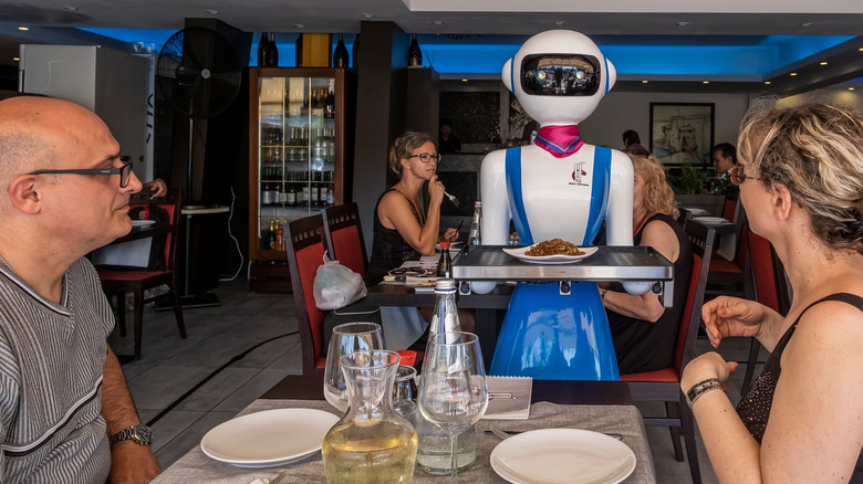 contemporary robot waiter serving food
