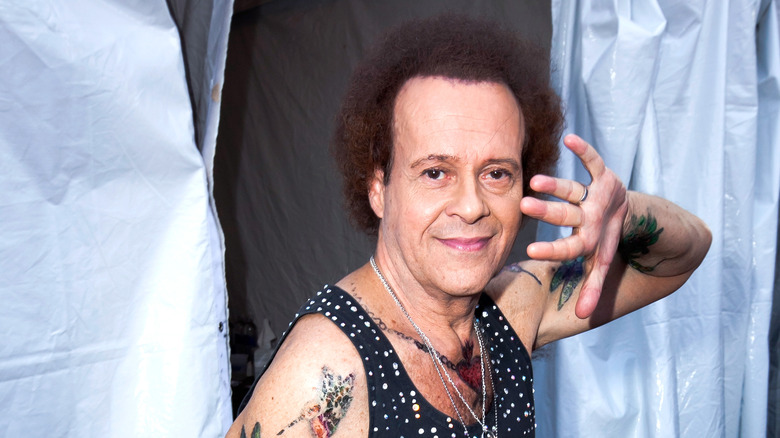 Richard Simmons with hand near face