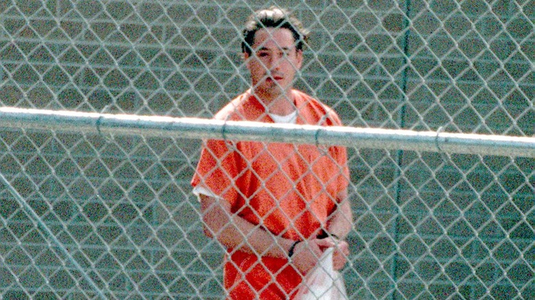 Robert Downey Jr. behind fence orange jumpsuit