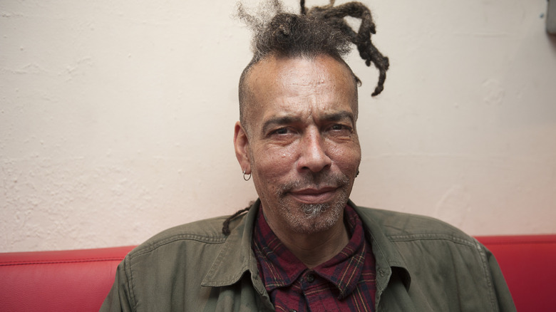 Chuck Mosley sitting on a couch and posing for a picture in 2016