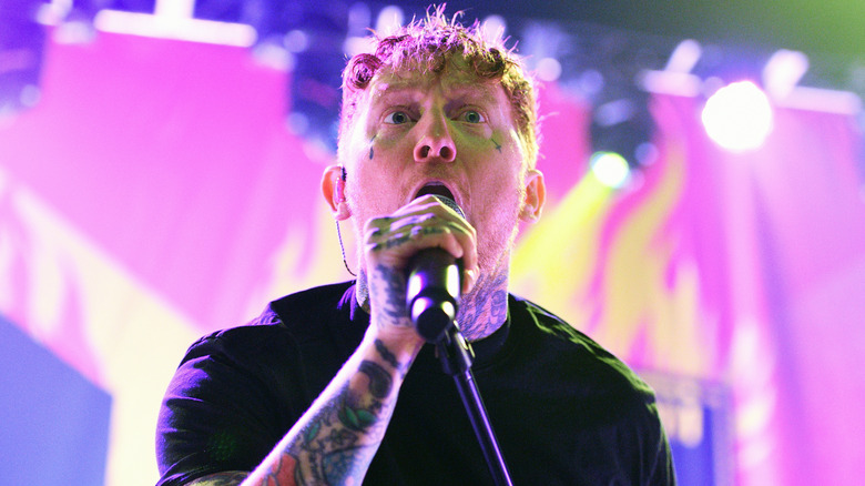 Frank Carter singing on stage with the Sex Pistols at the O2 Forum in 2024