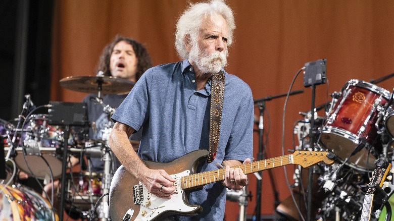 Bob Weir playing guitar onstage 2023