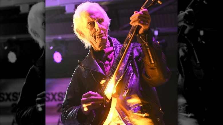 Robby Krieger playing guitar onstage 2023