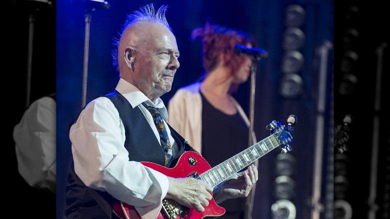 Robert Fripp playing guitar onstage 2021