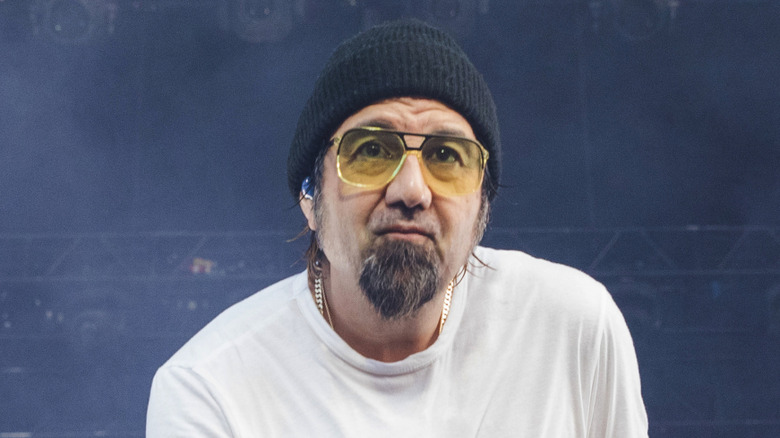 chino moreno of deftones in yellow glasses sneering during a concert