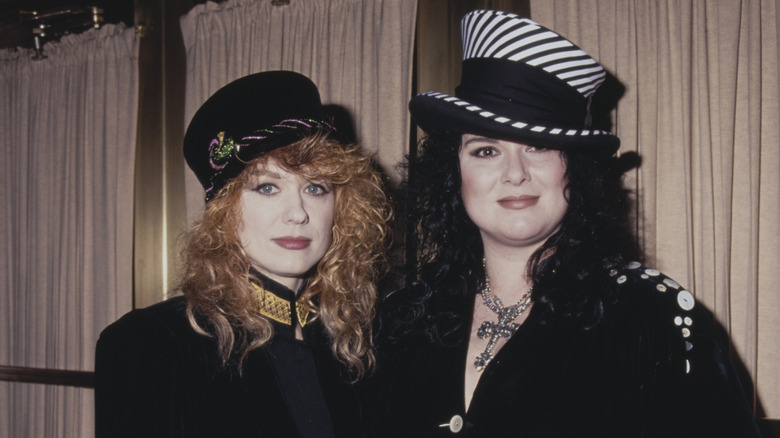 ann wilson and nancy wilson of heart in the 90s wearing hats