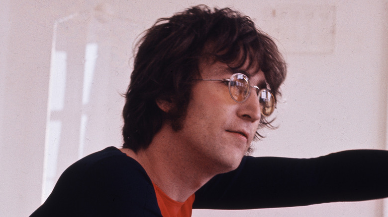 john lennon in profile in white room in the 70s