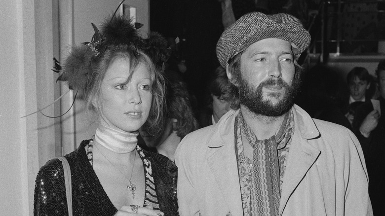 pattie boyd looking off eric clapton in hat squinting