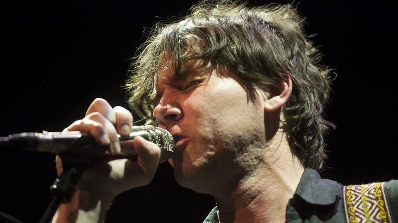 Cass McCombs singing into a microphone