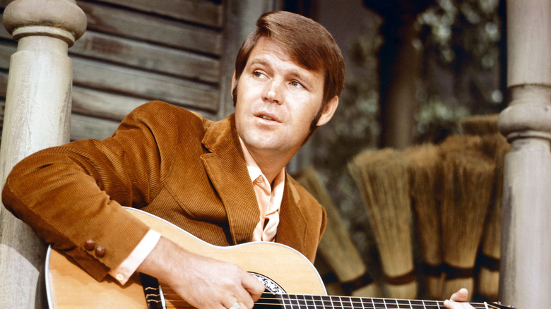 Glen Campbell holds guitar