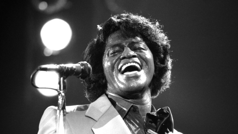 James Brown singing in front of microphone