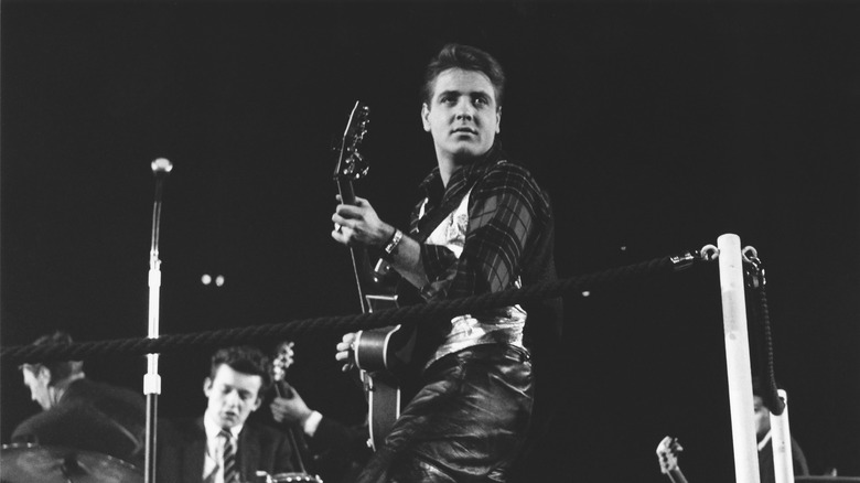 Eddie Cochran looking over his shoulder while playing guitar