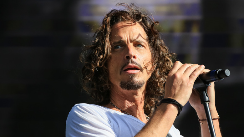 Chris Cornell holding a microphone on stage