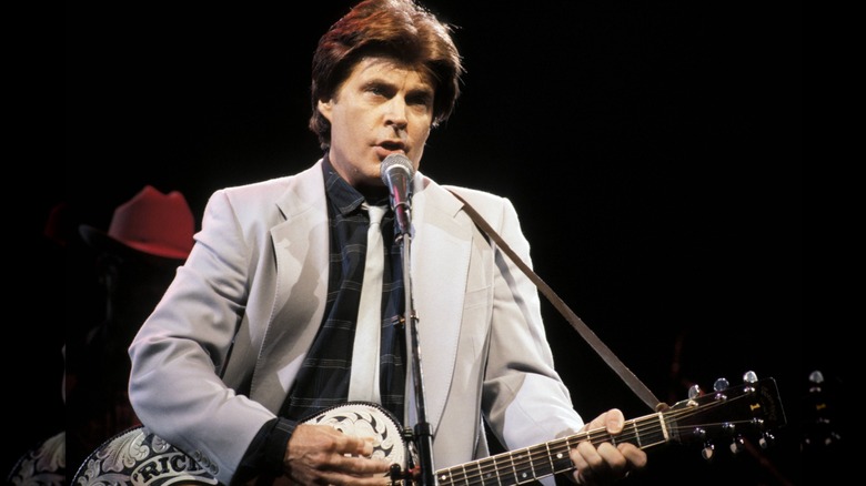 Rick Nelson playing the guitar and singing on stage