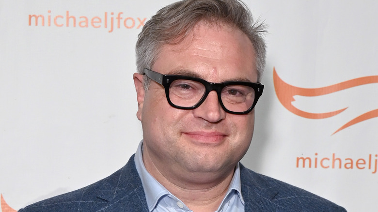 Steven Page blue suit smiling glasses at event