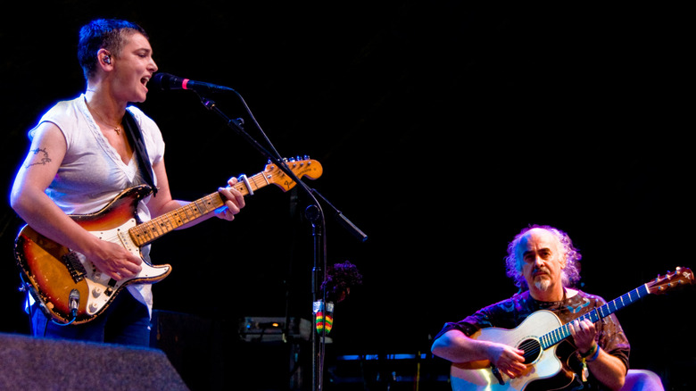 Sinead O'Connor and Steve Cooney playing guitars onstage