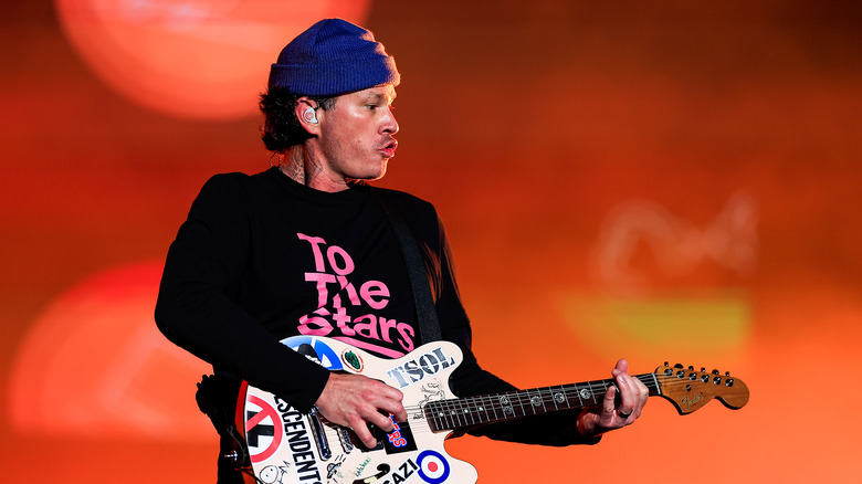 Tom DeLonge profile playing guitar