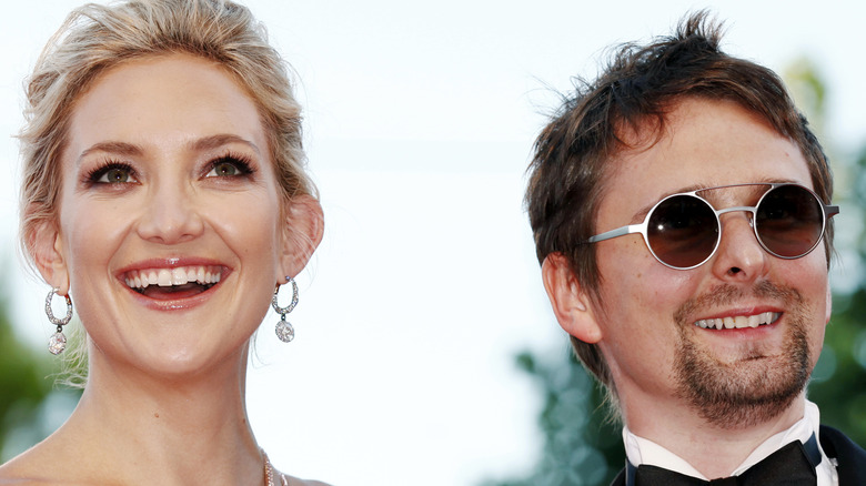 Kate Hudson and Matt Bellamy looking up smiling