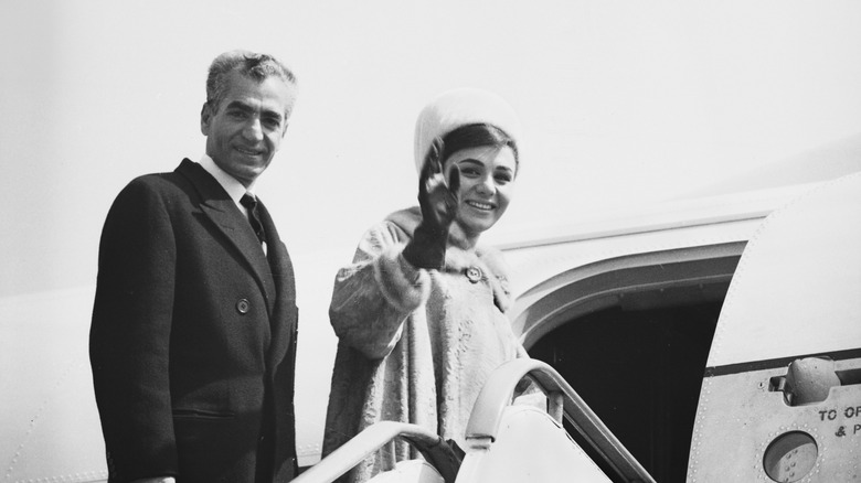 Shah Mohammad Reza Pahlavia and Empress Farah getting on a plane