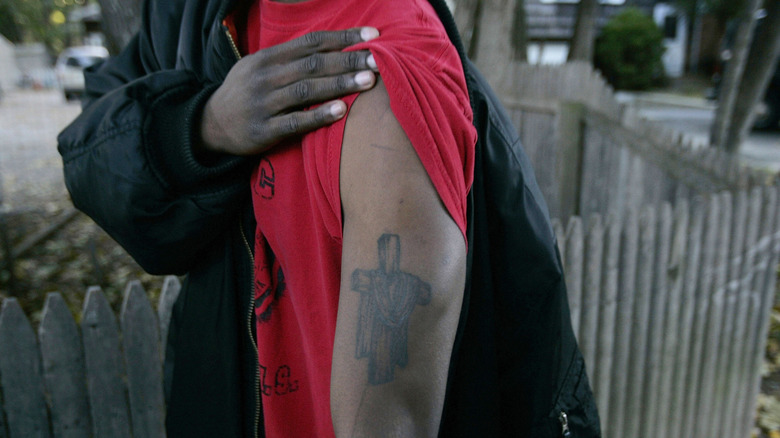 Blood gang member shows off one of his tattoos