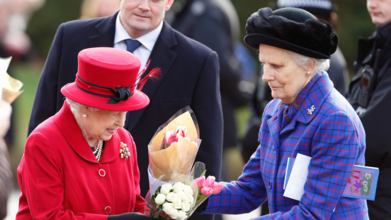 A lady-in-waiting collecting the Queen's flowers