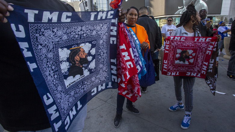 people holding red and blue bandanas