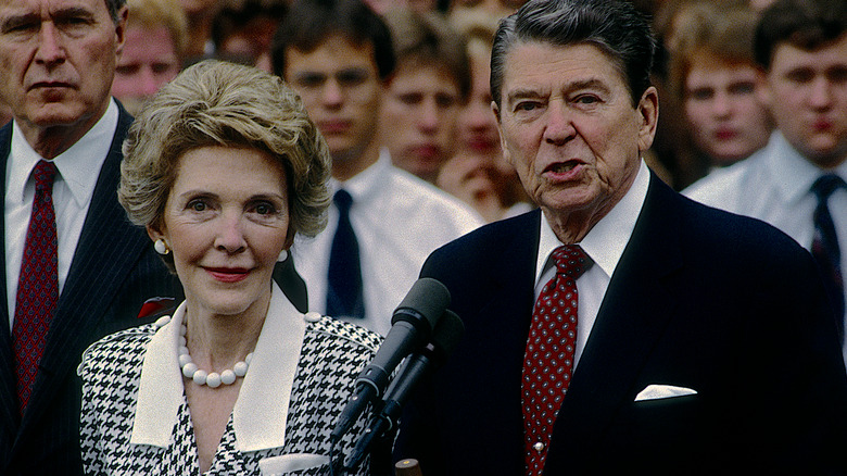 Nancy Reagan stands by Ronald Reagan during speech