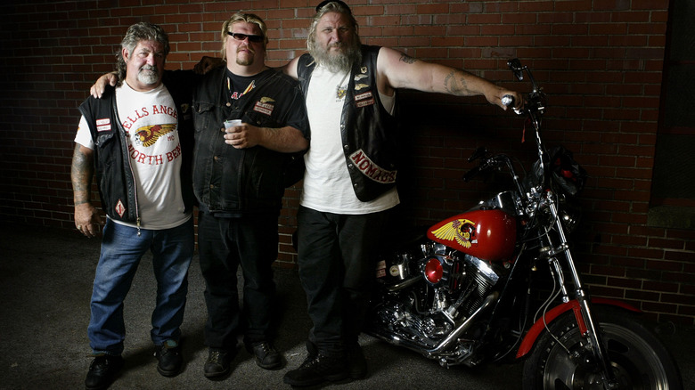 hells angels posing with a bike at an event