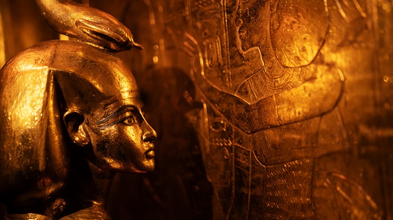 Golden goddess statue watching Tut's remains