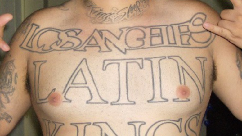 men's chest with Latin King tattoo