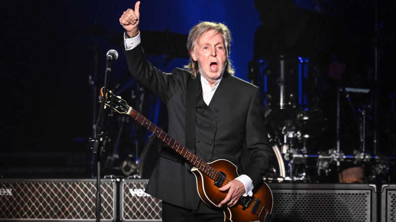 Paul McCartney performing on stage