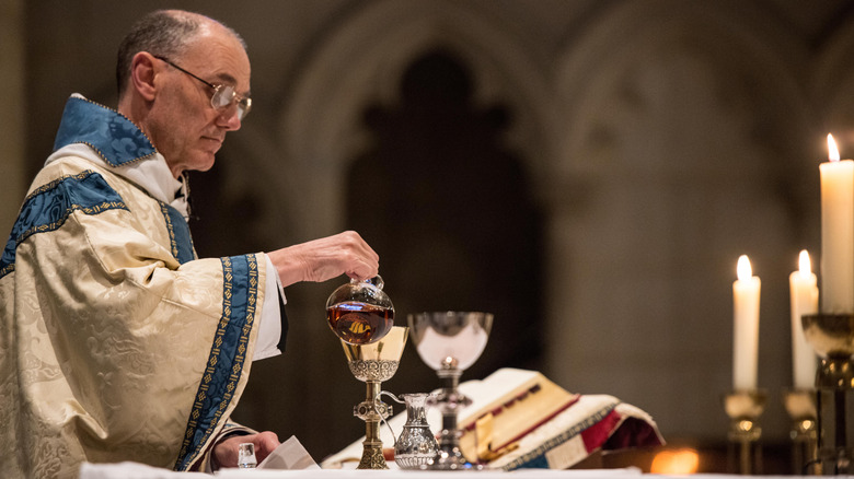 Monk prepares communion wine