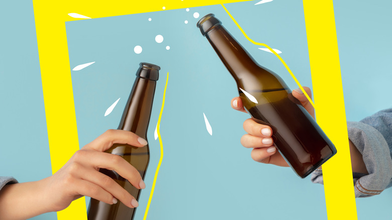 Two hands clinking beer bottles