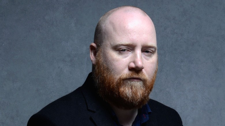 Jóhann Jóhannsson against a gray background