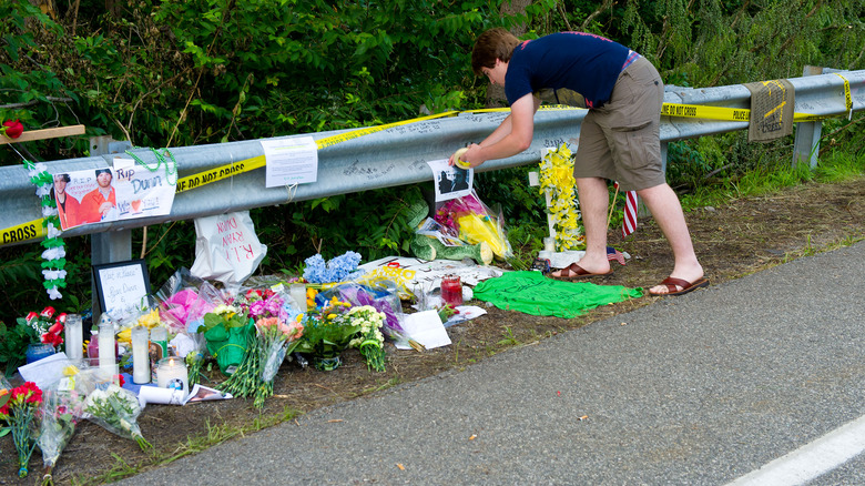 Person paying respects at Ryan Dunn crash site