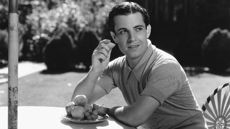 Ramon Novarro outside eating breakfast