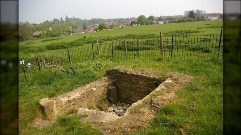 St. Rumbold's well surrounded by fence green grass